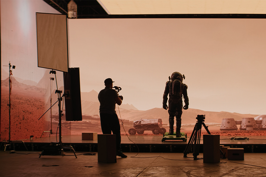 BTS Shot of virtual production stage with huge LED screens, shooting Mars scene